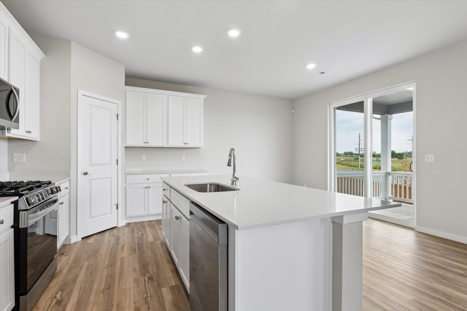 A kitchen with white cabinets.