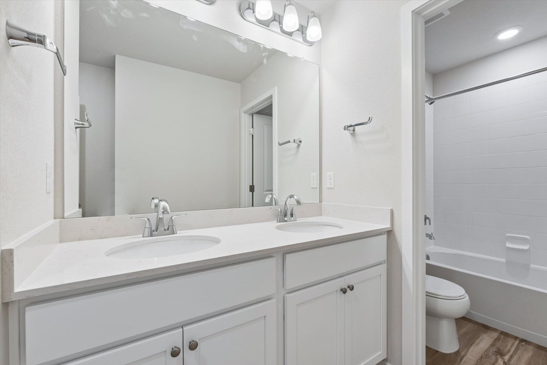 A bathroom with a large mirror.