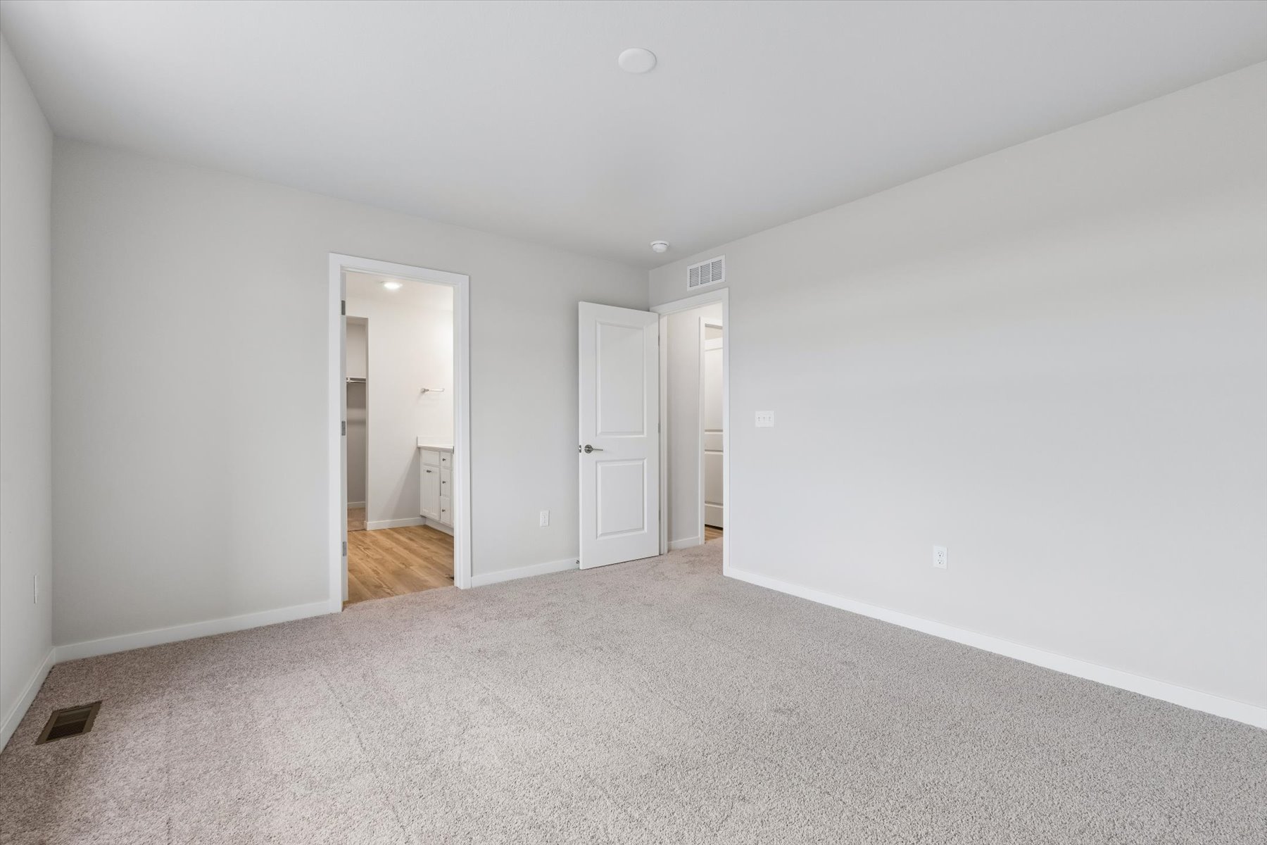 A hallway with white walls.