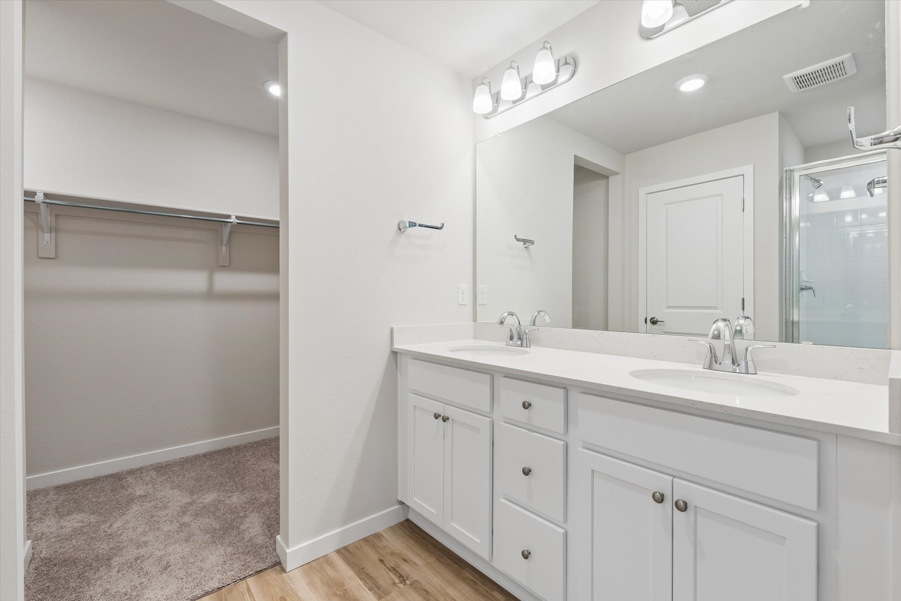 A bathroom with a large mirror.