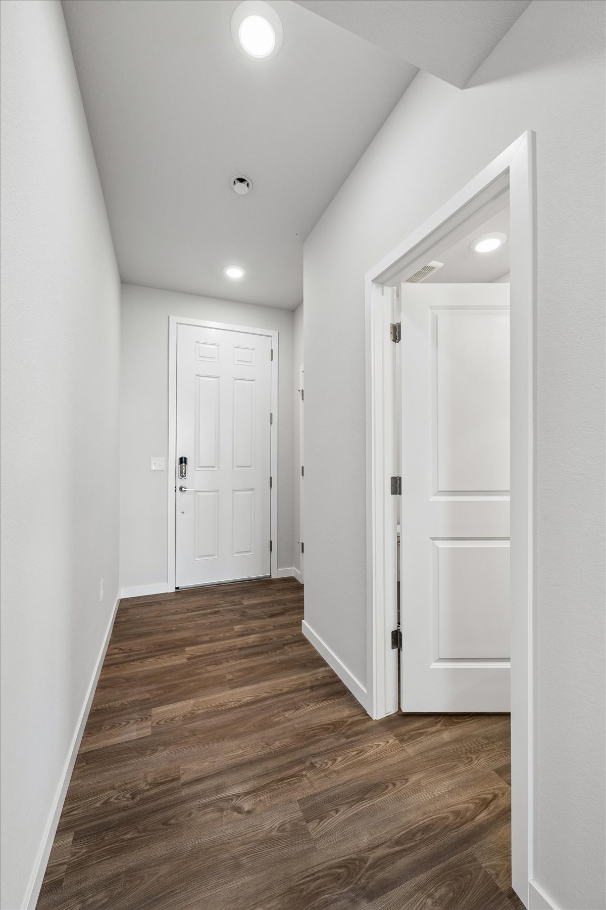 A hallway with white doors.