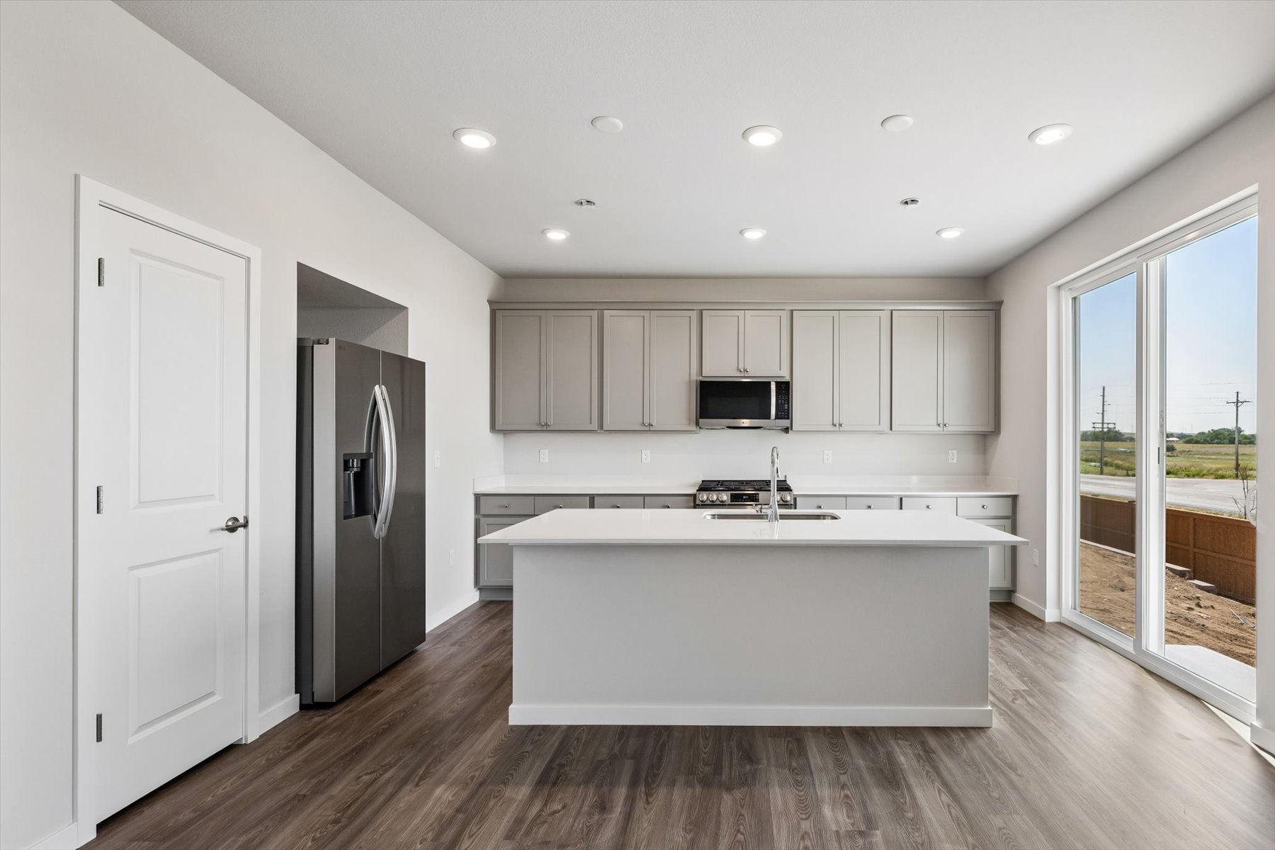 A kitchen with white cabinets.