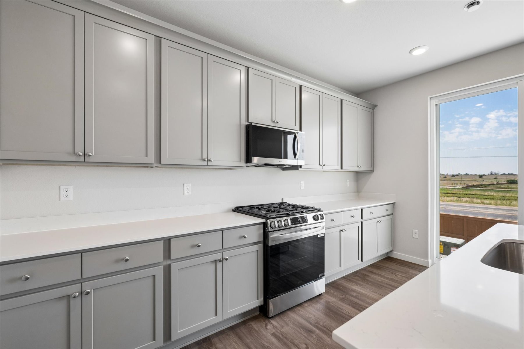 A kitchen with white cabinets.