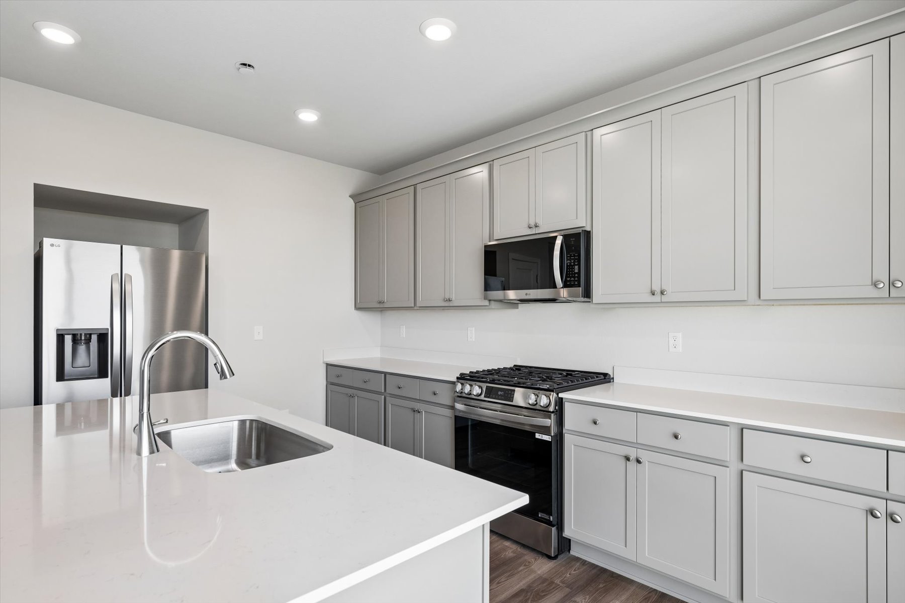 A kitchen with white cabinets.