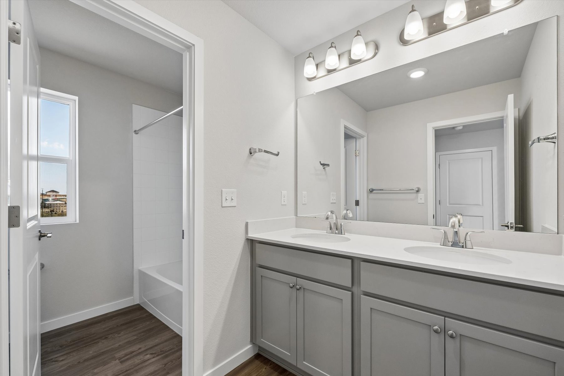 A bathroom with a large mirror.
