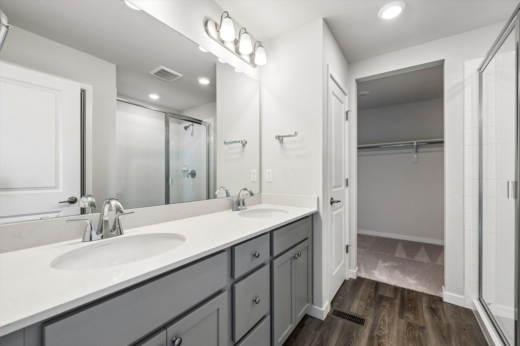 A bathroom with a large mirror.
