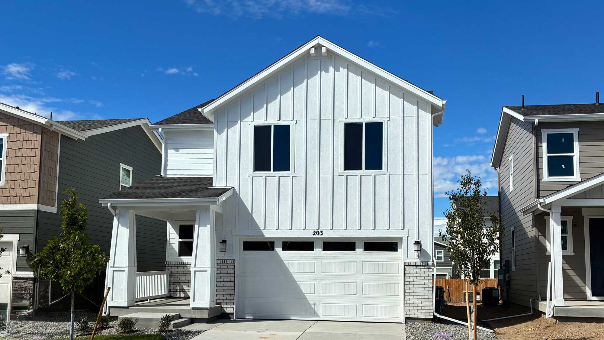 A white house with a garage.