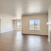 Great room and breakfast nook and fireplace of the ranch style Telluride plan by Century Communities