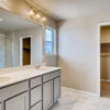 Primary suite private bath with dual vanity and walk in closet. Part of the two-story Lewis plan by Century Communities