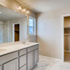Primary suite private bath with dual vanity and walk in closet. Part of the two-story Lewis plan by Century Communities