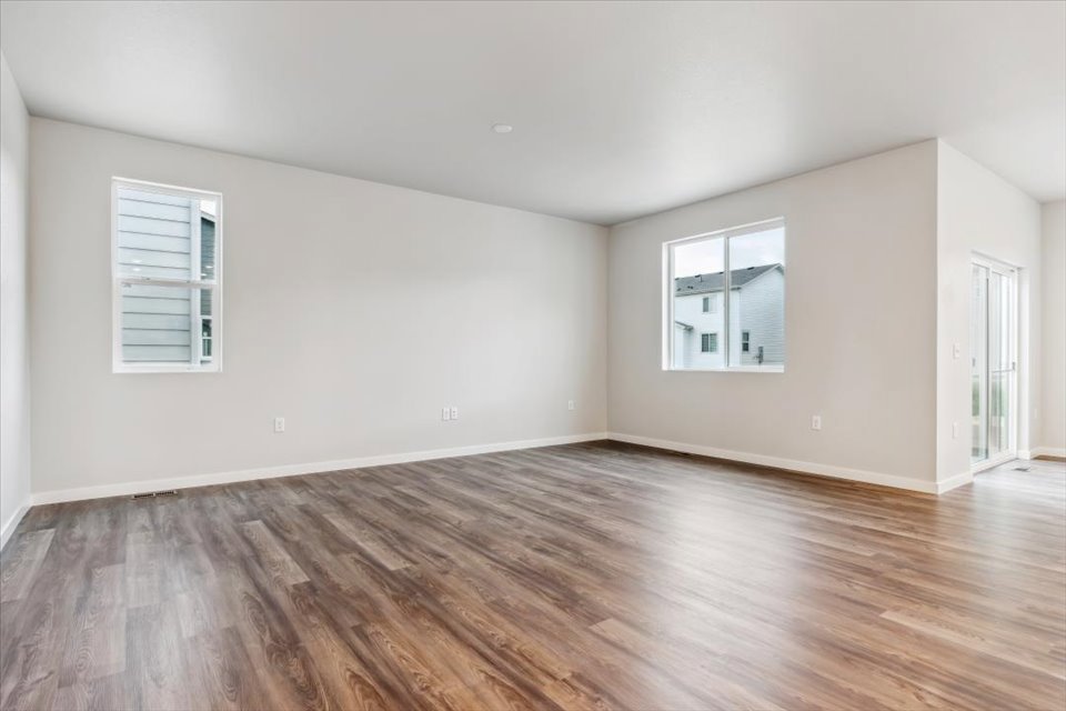 A room with a wood floor and a window.