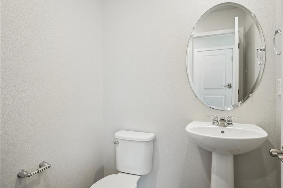 A bathroom with a mirror and sink.
