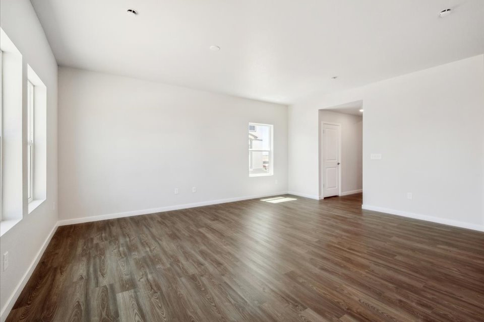 A room with a wood floor and white walls.