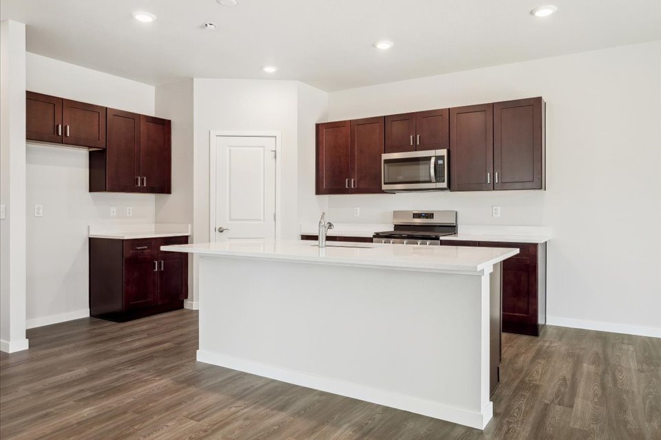A kitchen with wooden cabinets.