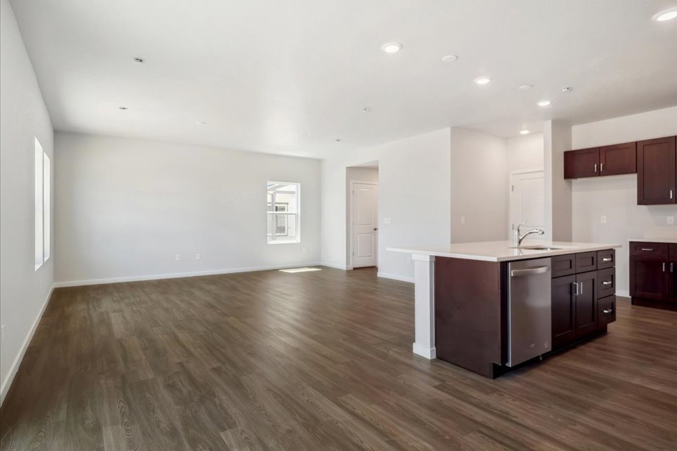 A large kitchen with wooden floors.