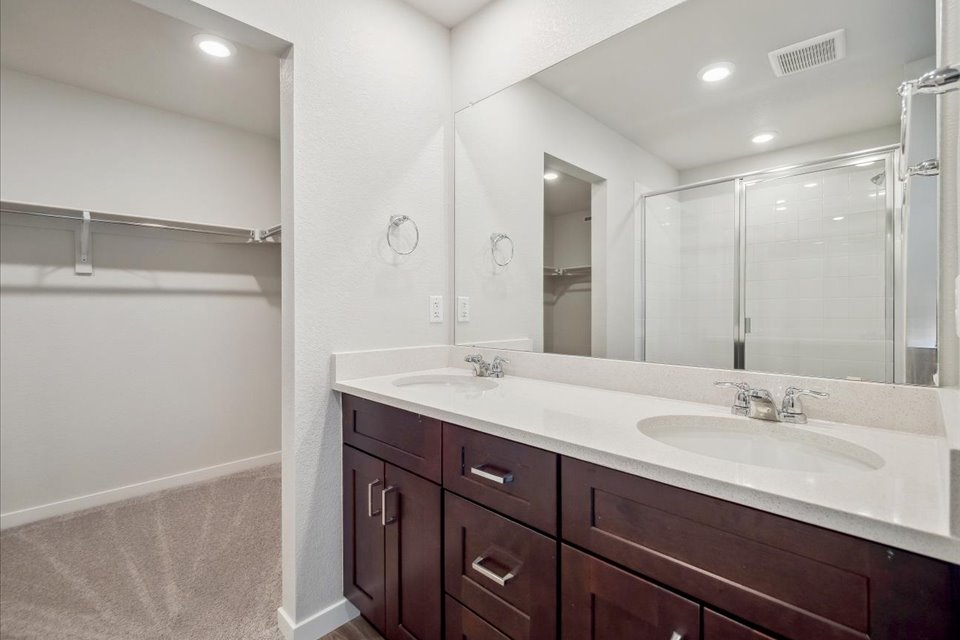 A bathroom with a large mirror.