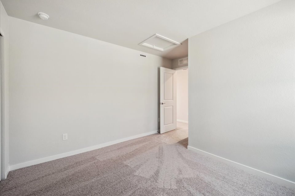 A hallway with white walls.