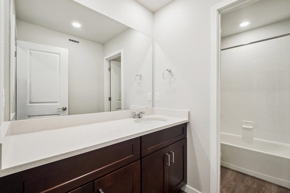 A bathroom with a large mirror.
