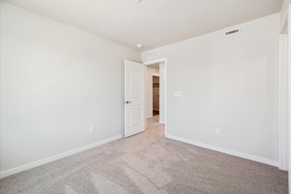 A hallway with white walls.