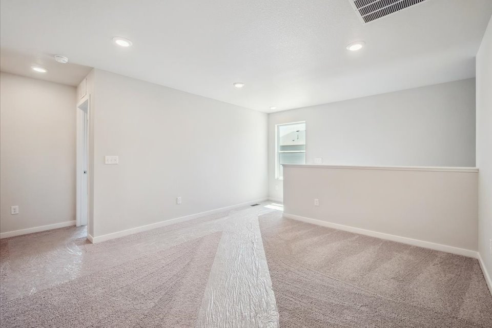 A room with a rug and a carpet.