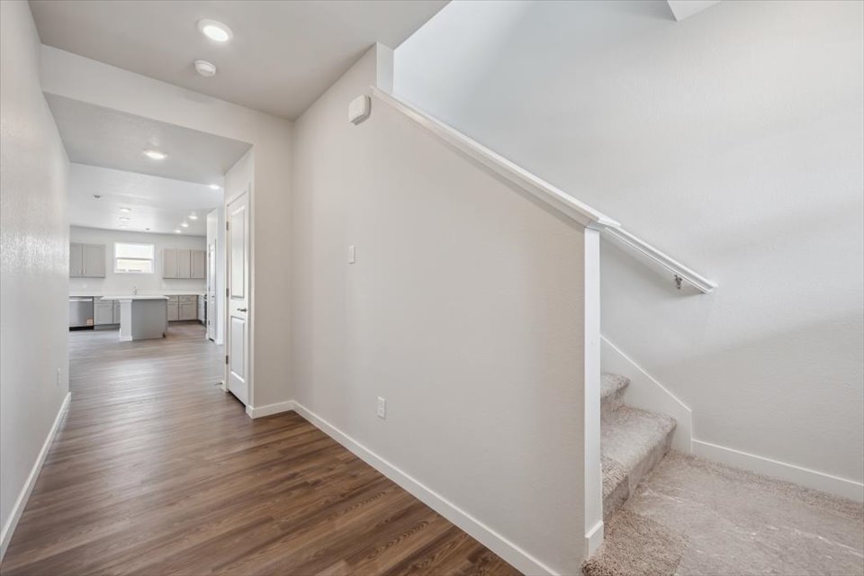 A white room with a wood floor.