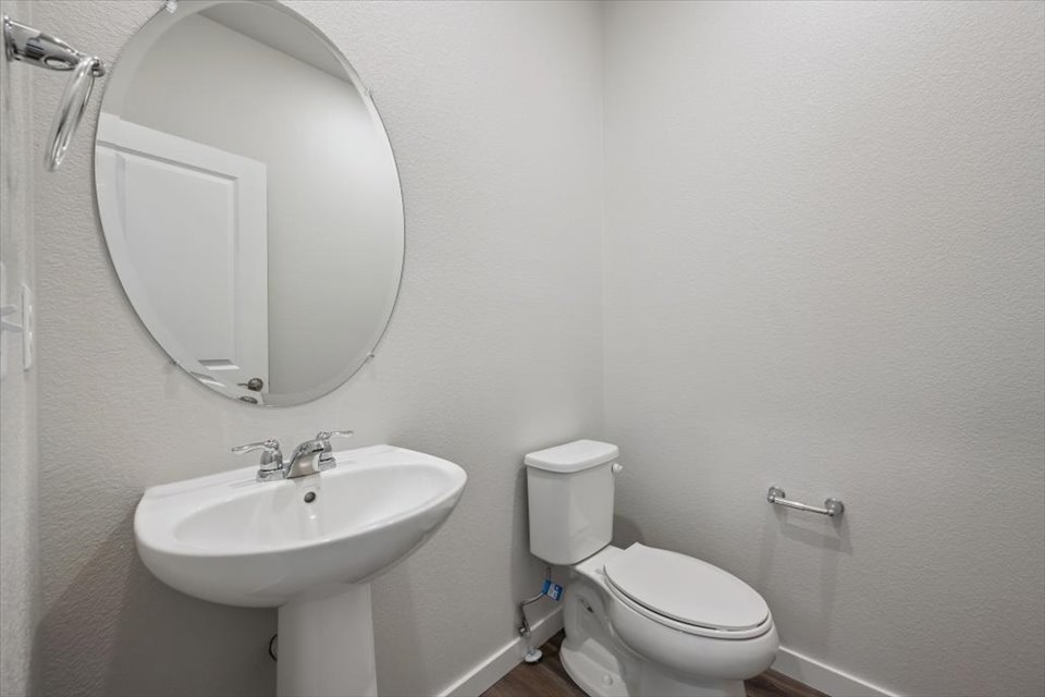A bathroom with a round mirror.