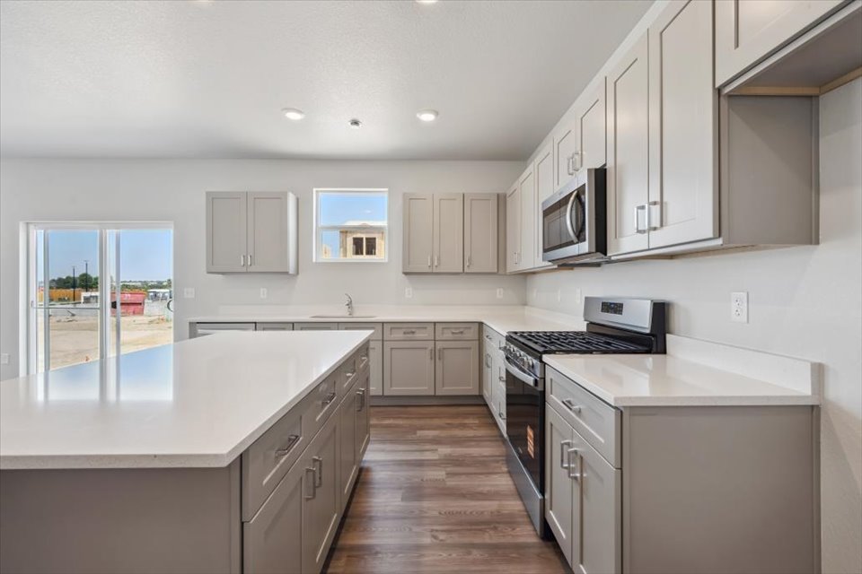 A kitchen with white cabinets.