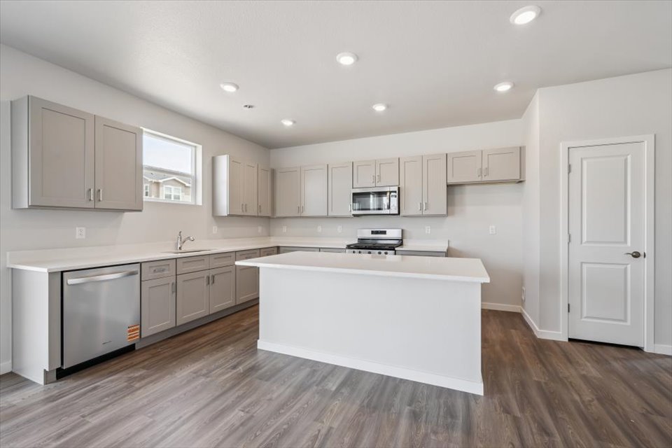 A kitchen with white cabinets.