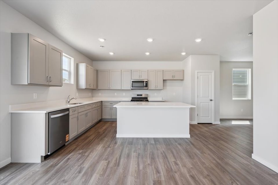 A kitchen with white cabinets.