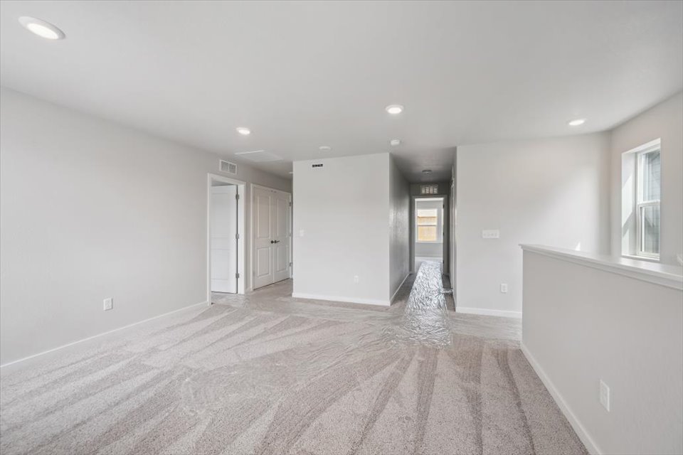A room with white walls and a wood floor.