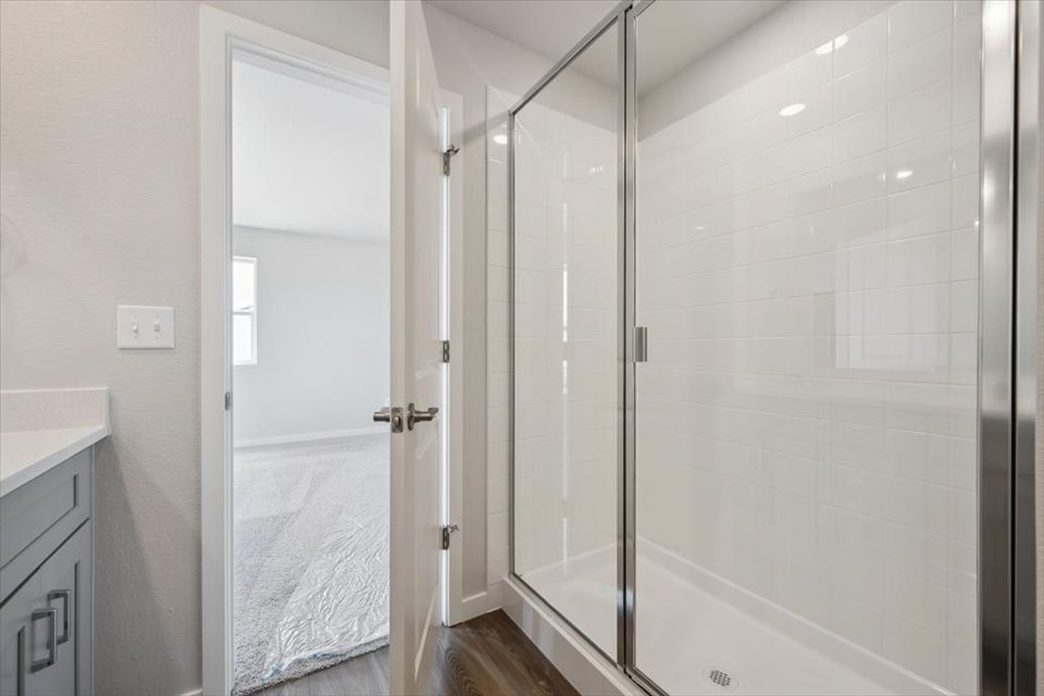 A shower with a glass door.