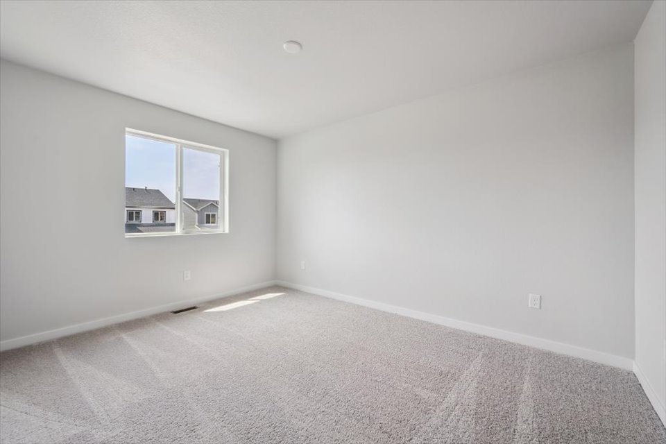 A room with a window and a carpet.
