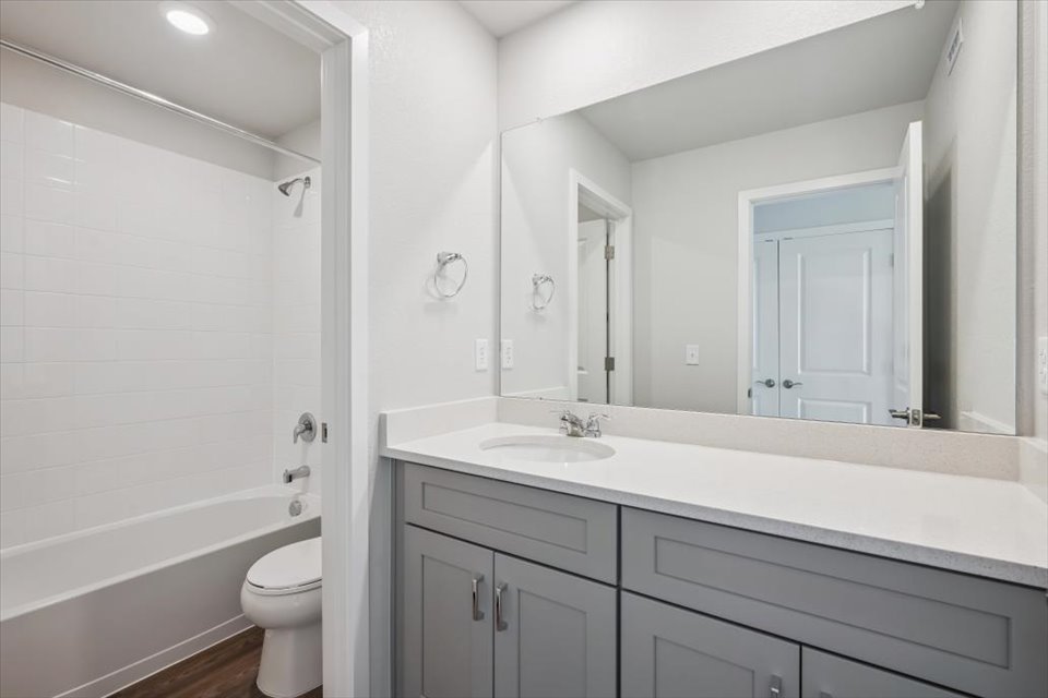 A bathroom with a sink toilet and bathtub.
