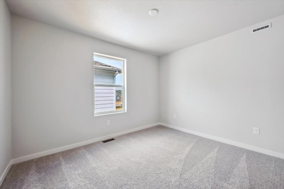 A room with a window and a carpet.