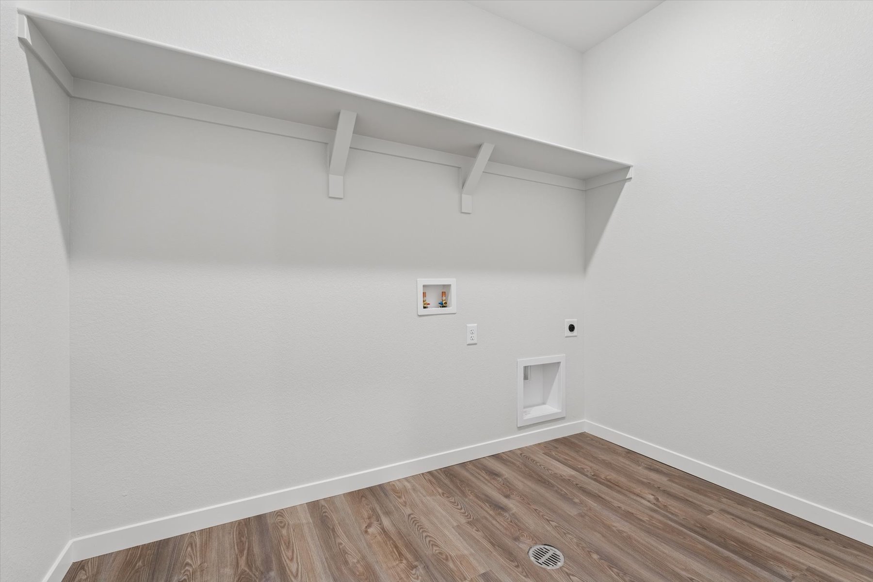 A room with a wood floor and a white ceiling.