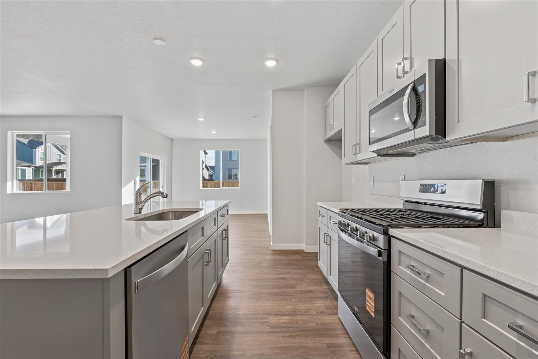 A kitchen with white cabinets.