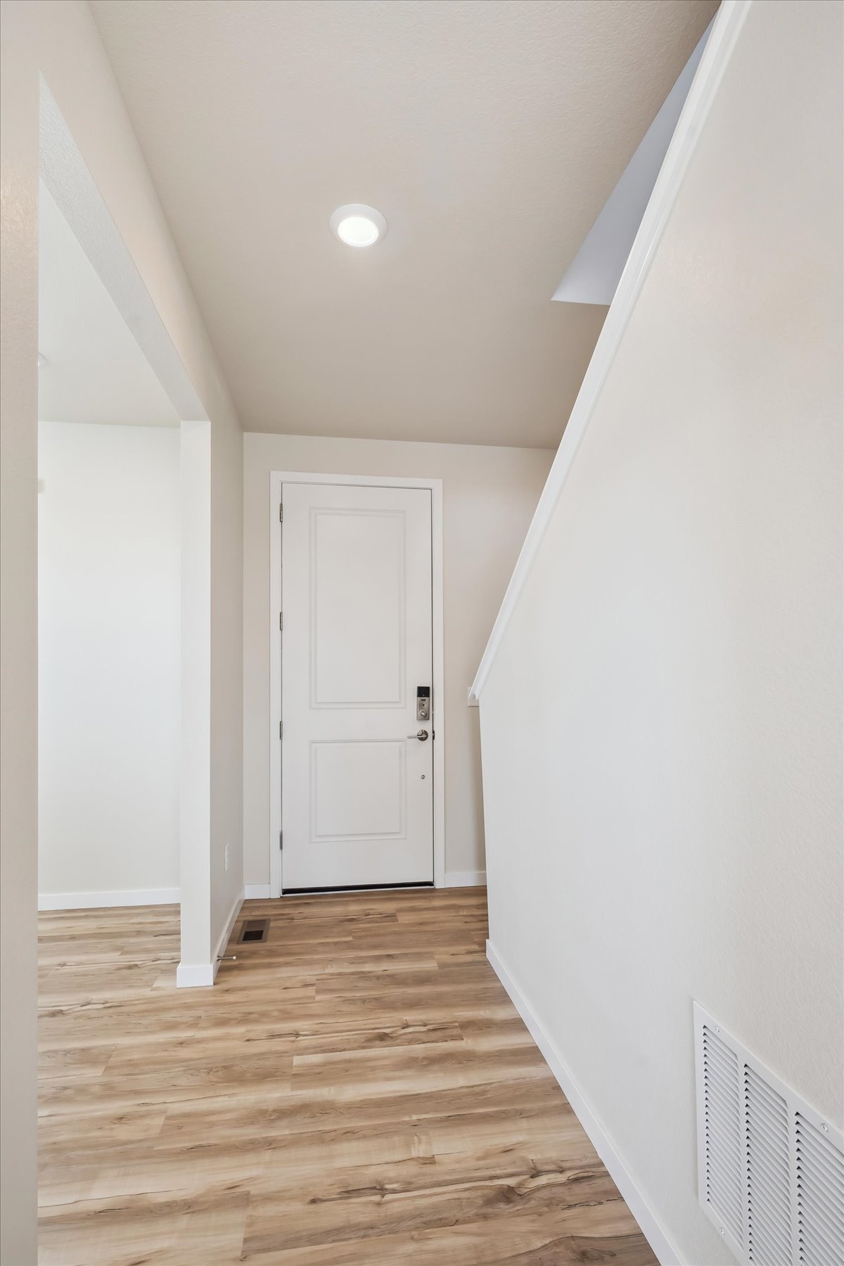 A hallway with white walls.