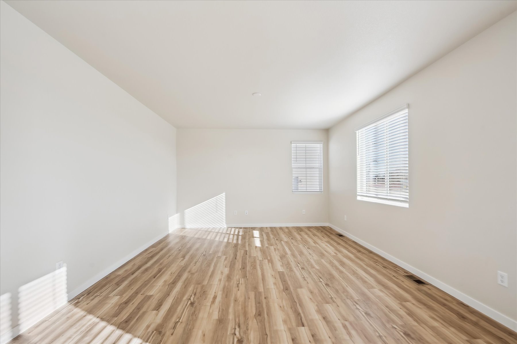 A room with a wood floor and a wood floor.
