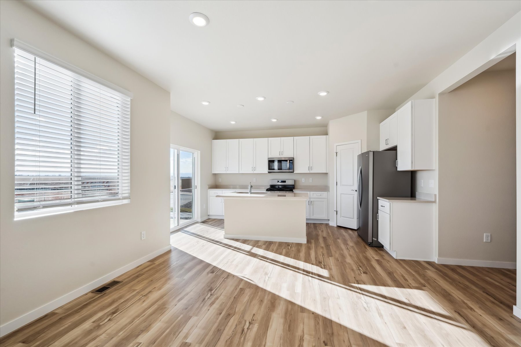 A kitchen with white cabinets.