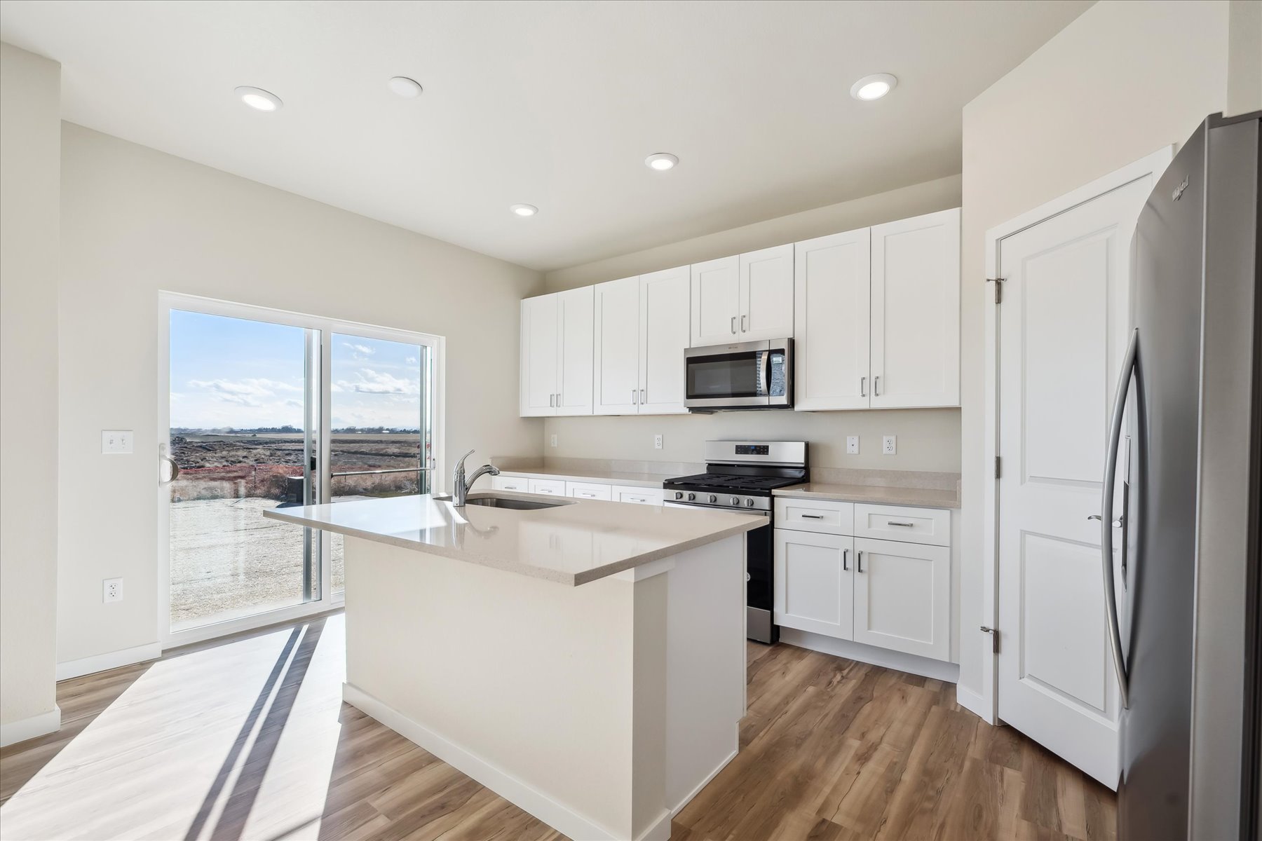 A kitchen with white cabinets.