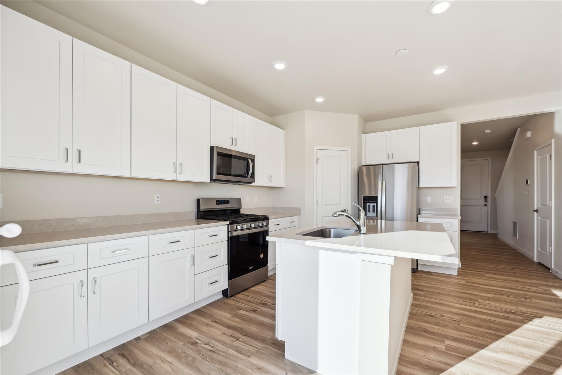 A kitchen with white cabinets.