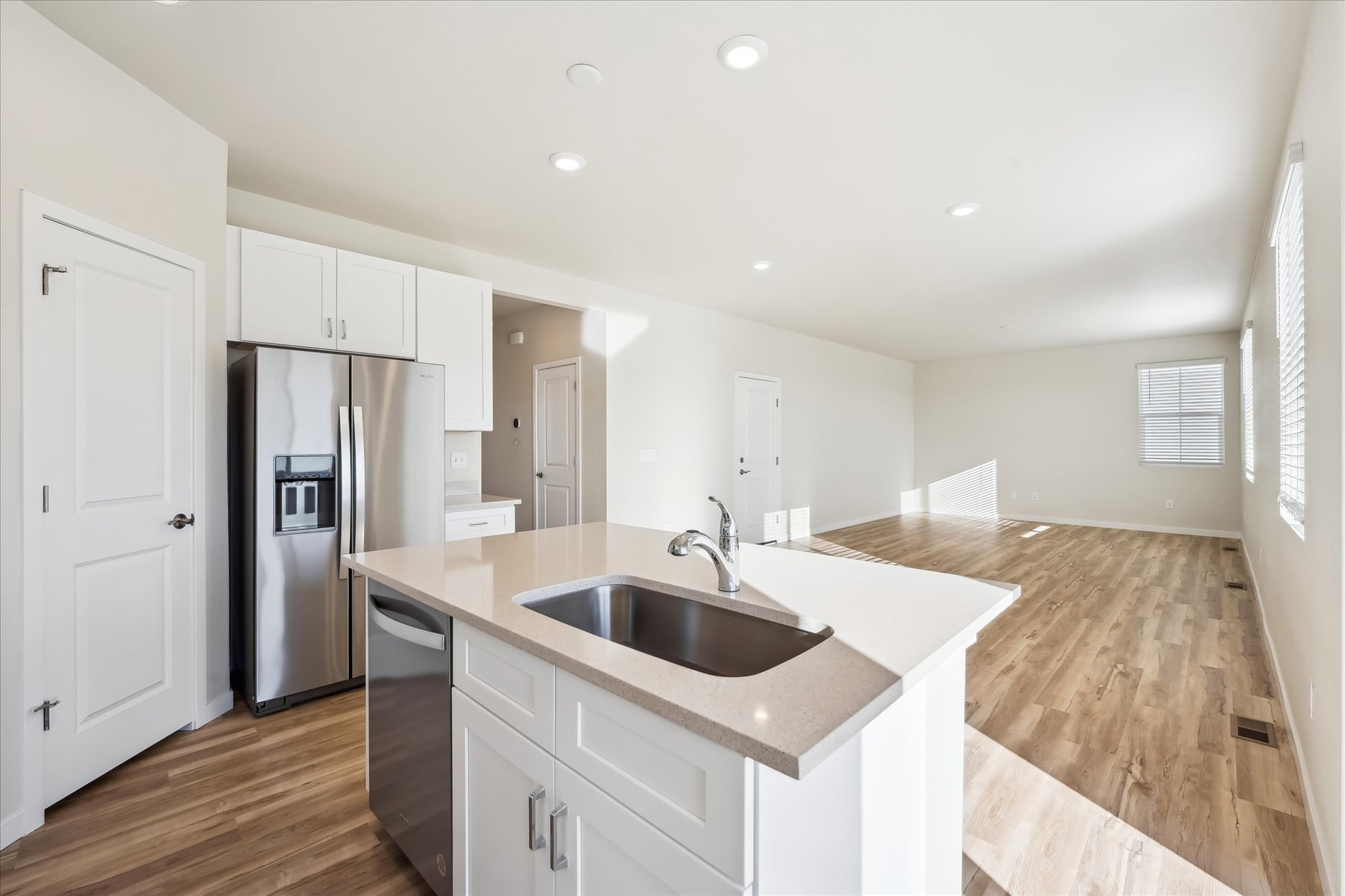 A kitchen with white cabinets.