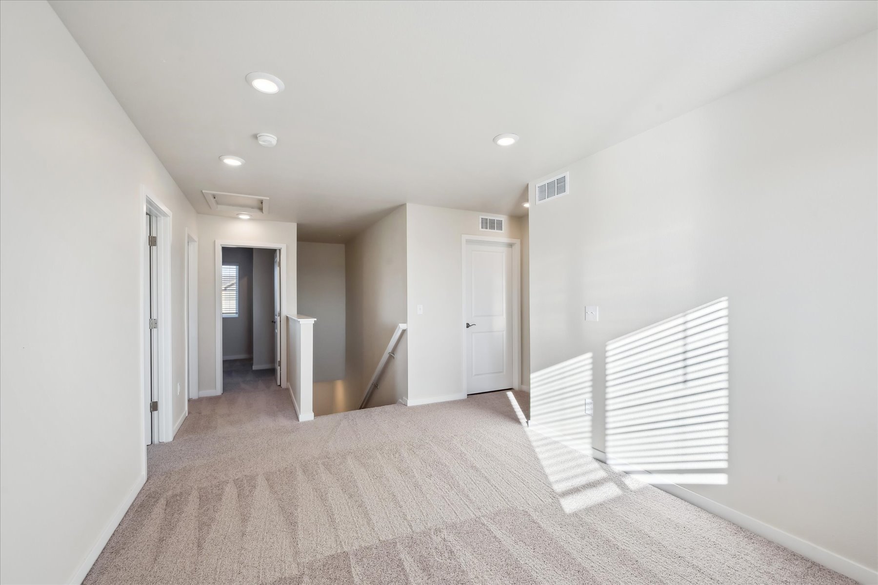 A hallway with white walls.