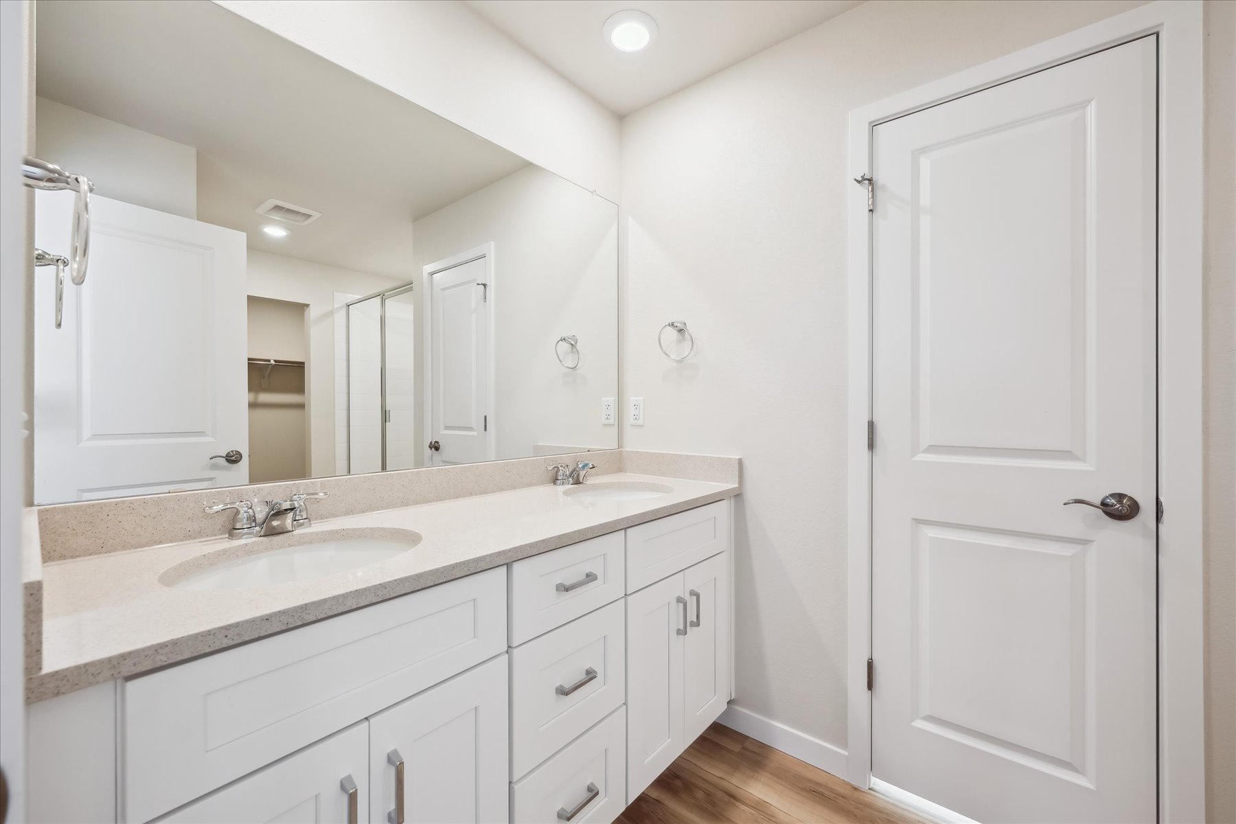 A bathroom with white cabinets.