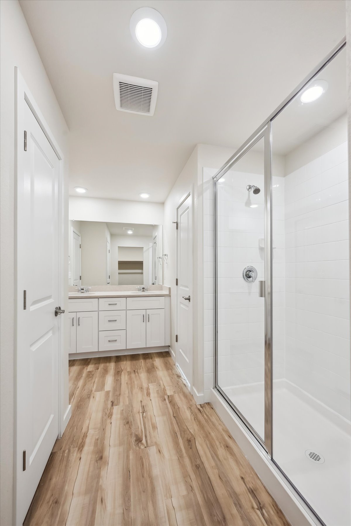 A white room with a glass door.