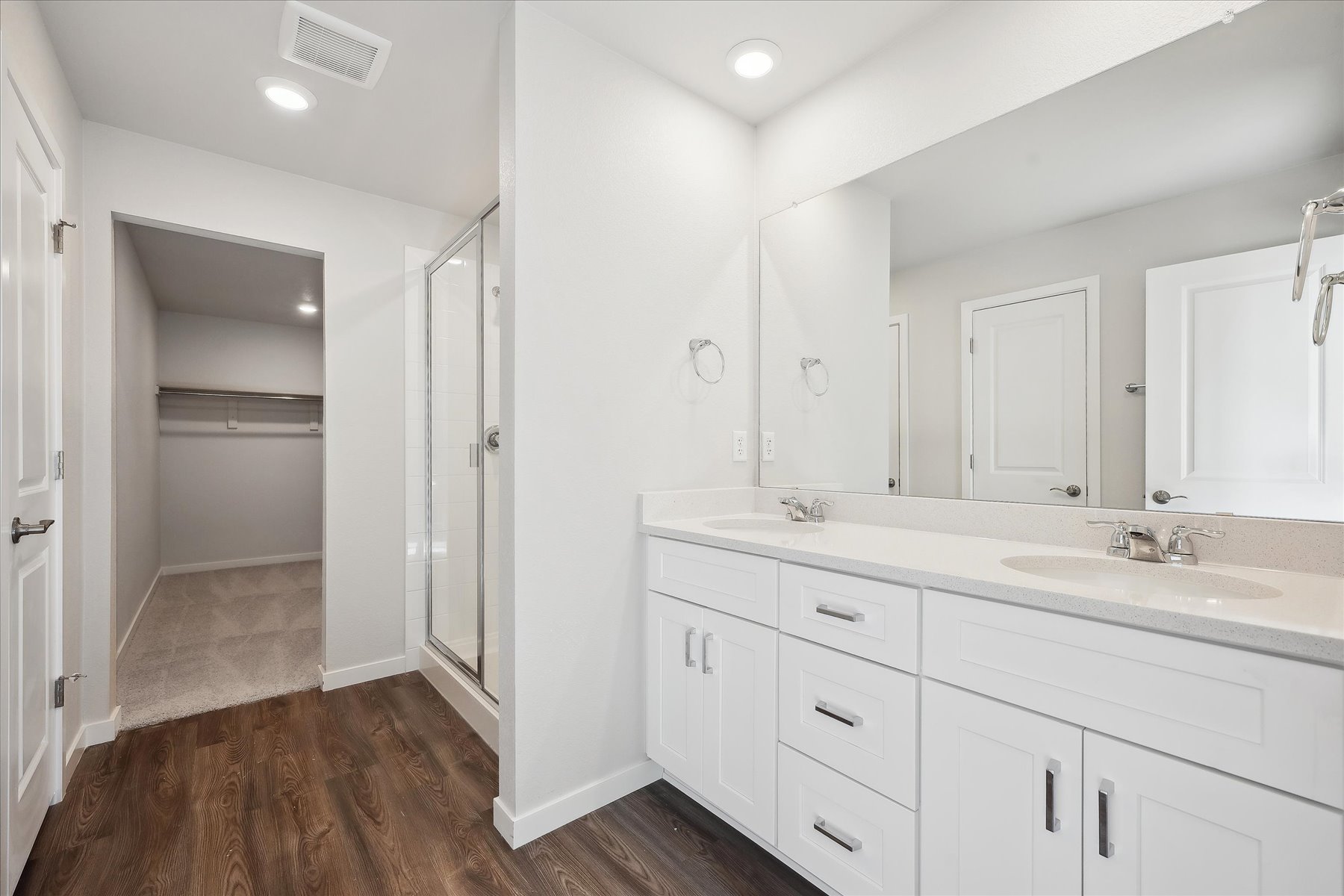 A bathroom with white cabinets.