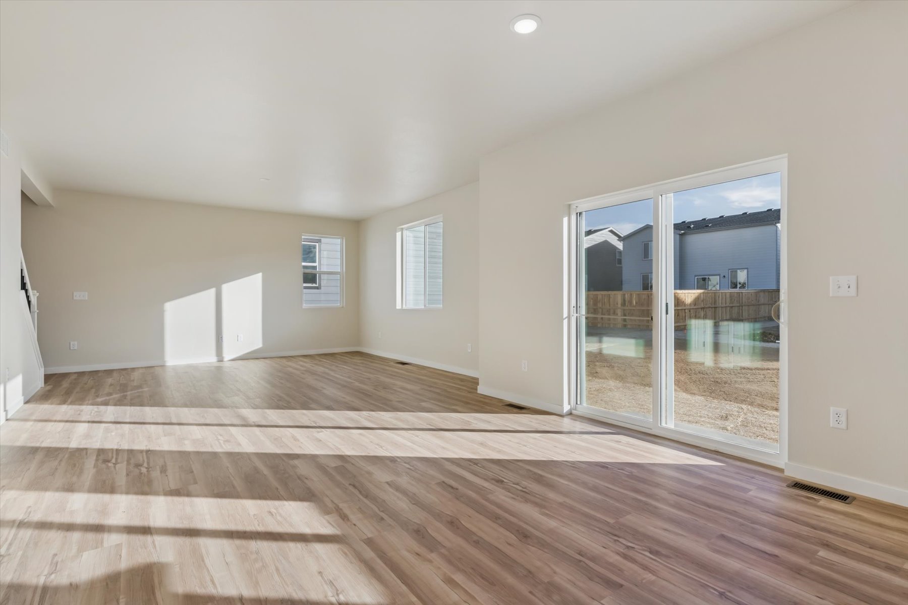 A room with a wood floor and a glass door.