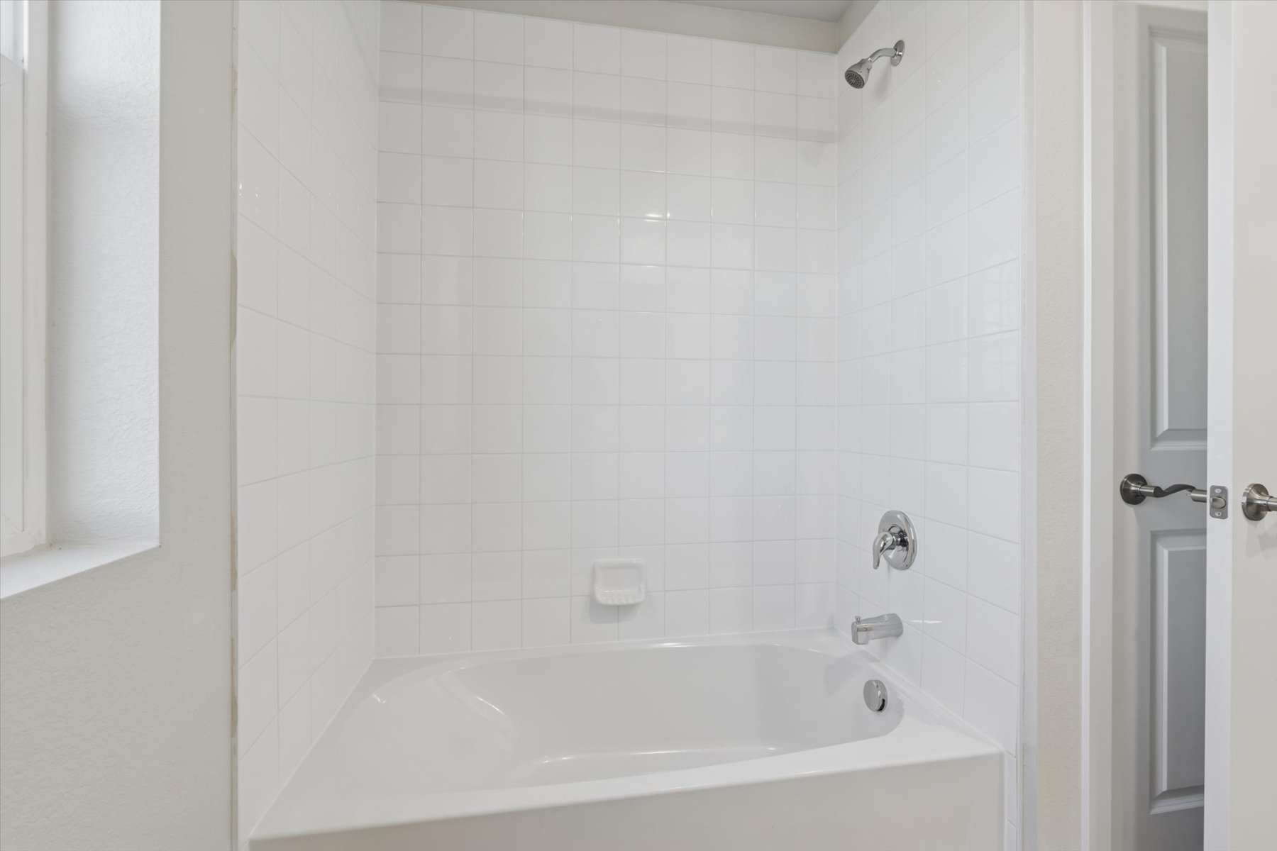 A bathtub in a bathroom.