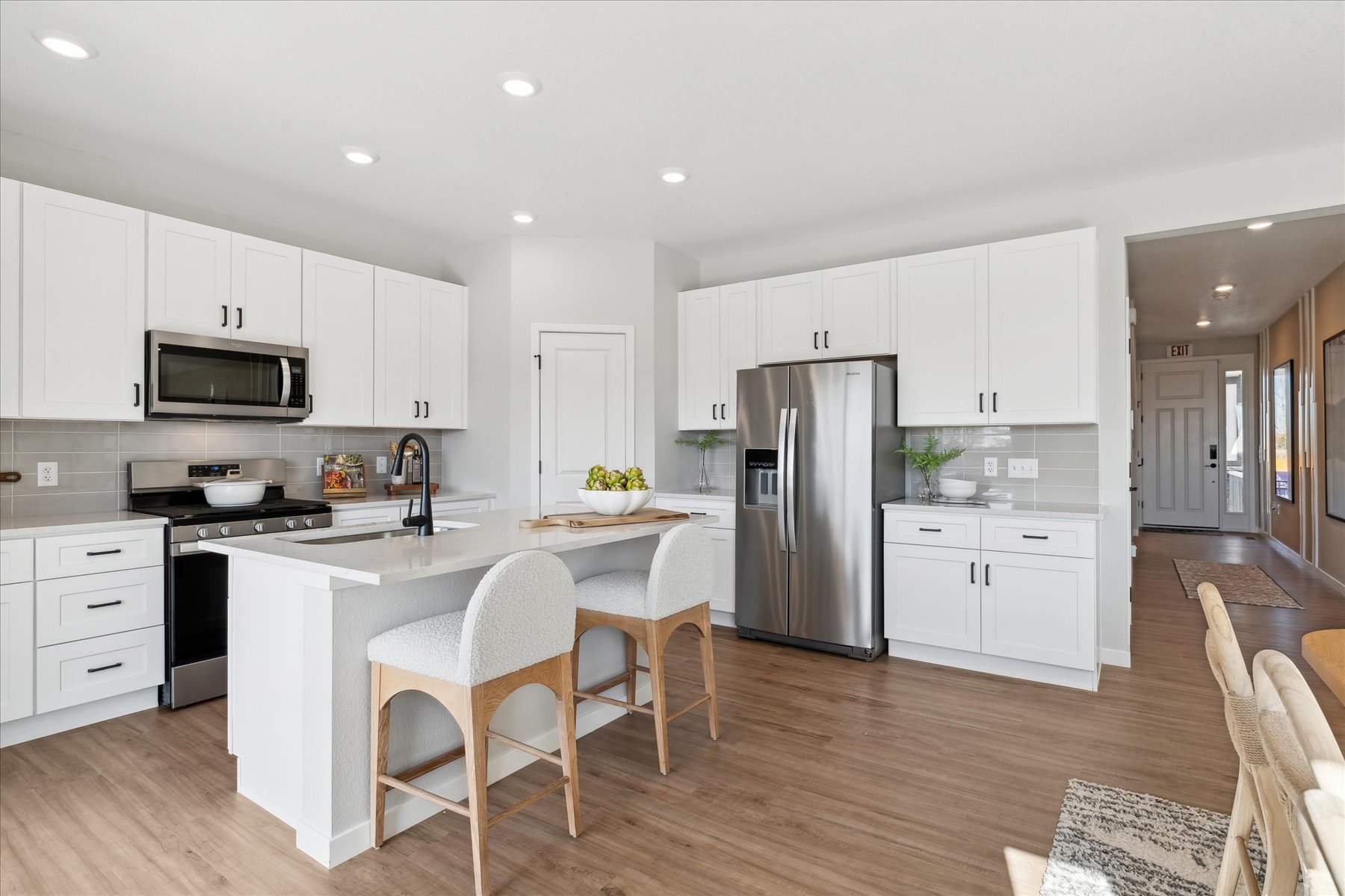 A kitchen with white cabinets.