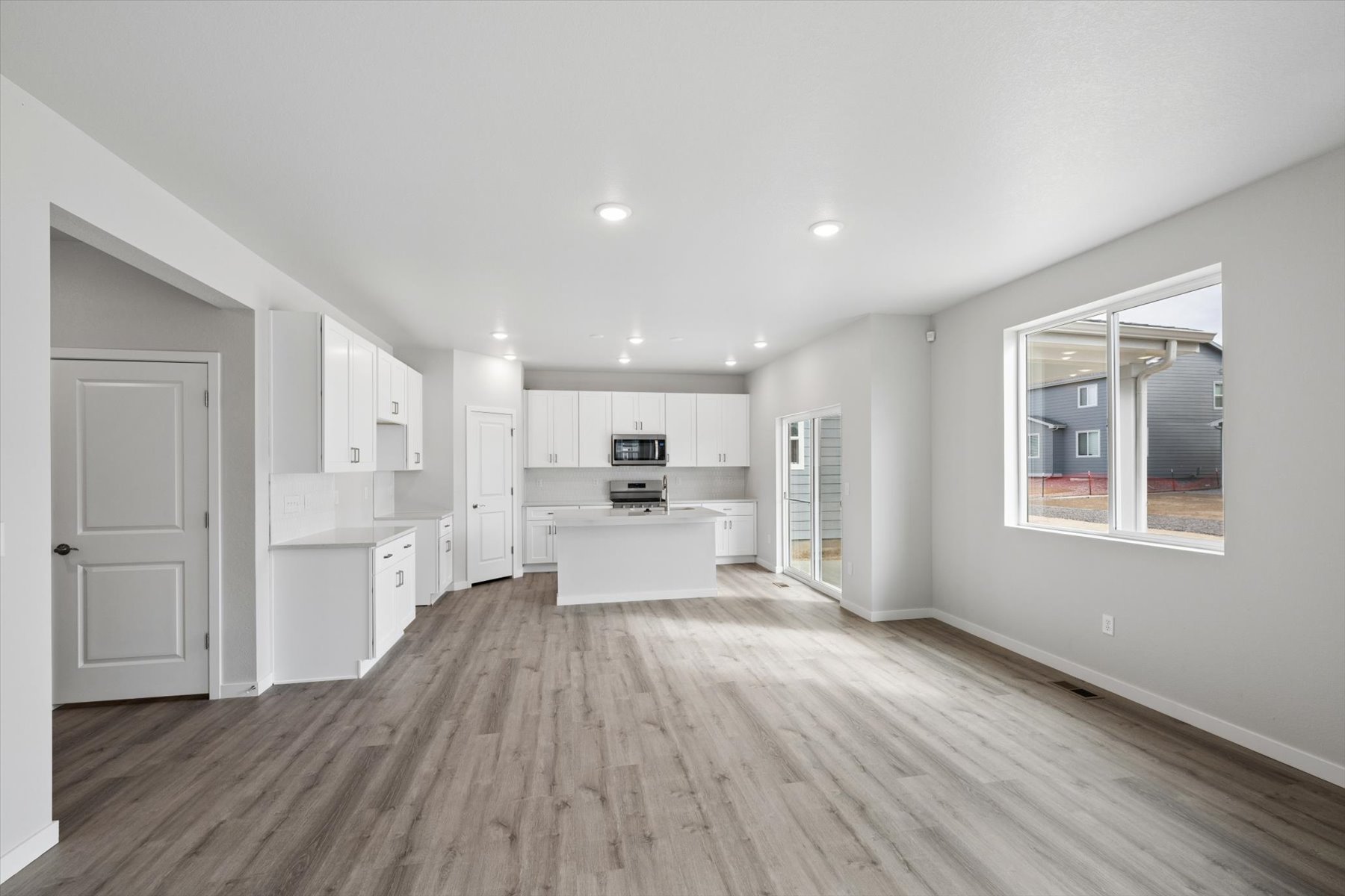 A large kitchen with white cabinets.